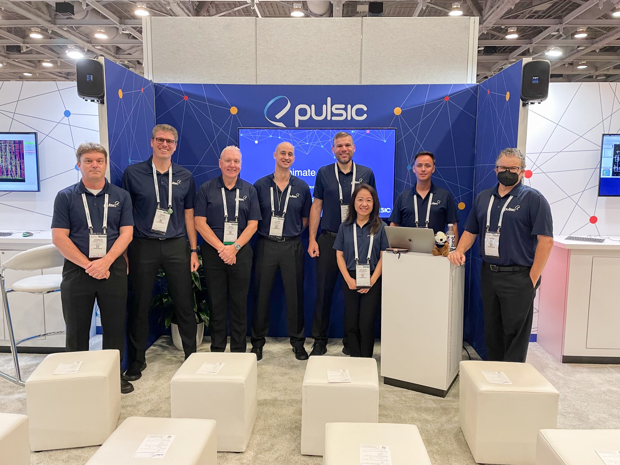 The Pulsic team smiling for the picture at DAC 59. They are all dressed in dark blue with Pulsic polo shirts.